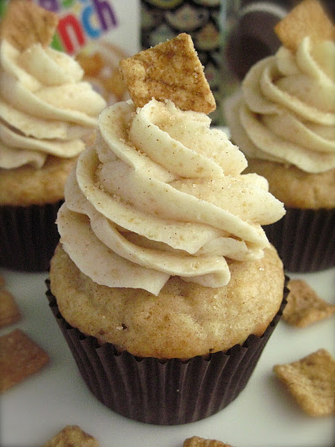 light brown cupcake with buttercream frosting and cereal square stuck in frosting