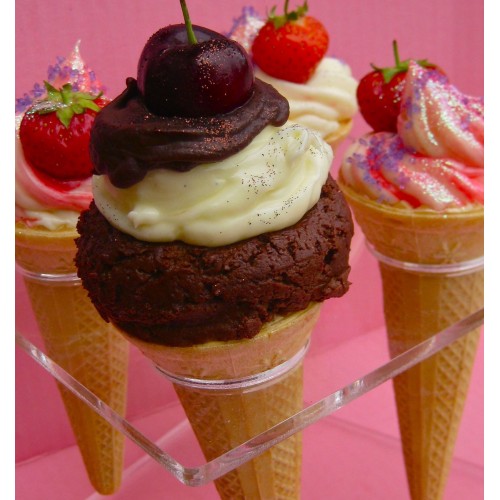 cherry topped cupcakes baked in a cone topped with a cherry