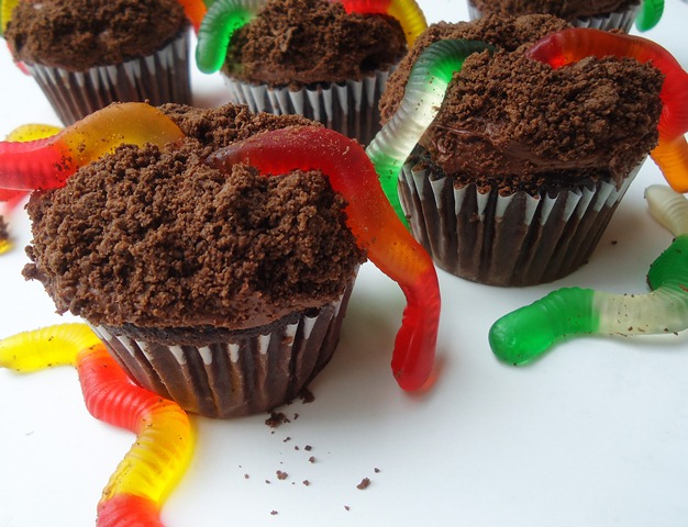 cupcakes that appear to have dirt on top with gummi worms coming out